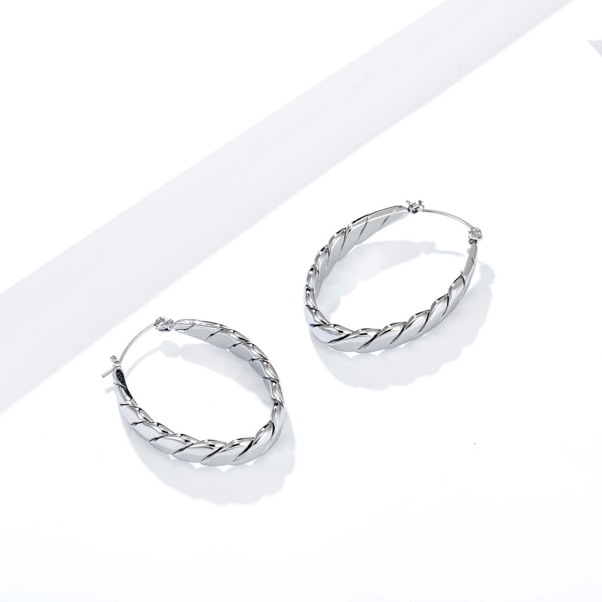 hoop earrings for women, twisted hoop earrings, chunky hoop earrings, geometric earrings, medium hoop earrings, oval earrings, sculpted earrings, textured hoop earrings, modern jewelry, fashion accessories