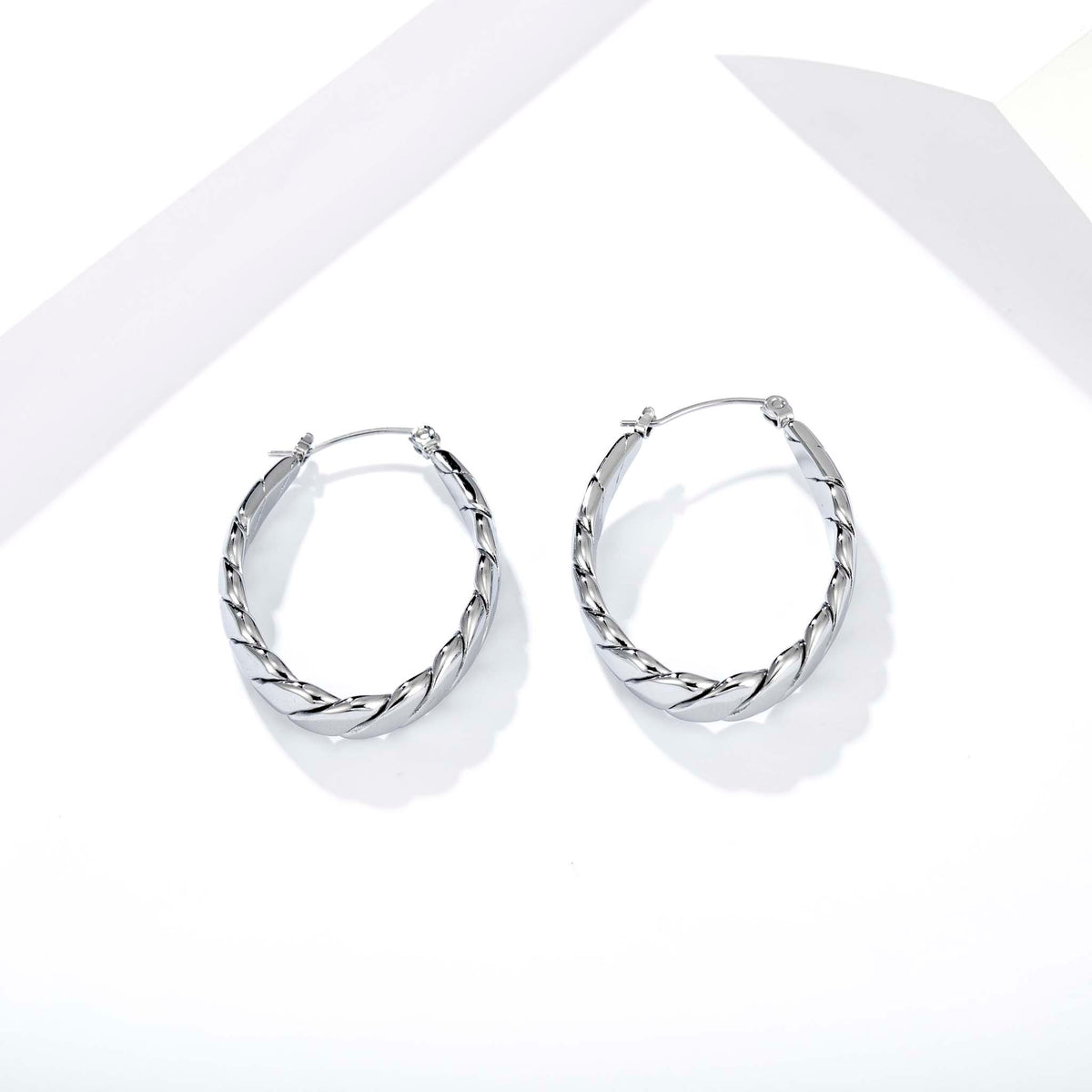 hoop earrings for women, twisted hoop earrings, chunky hoop earrings, geometric earrings, medium hoop earrings, oval earrings, sculpted earrings, textured hoop earrings, modern jewelry, fashion accessories